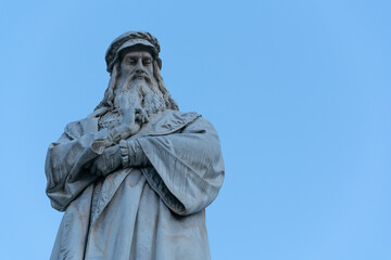 The Statue of Leonardo da Vinci on clear blue sky in Milano, Italy.