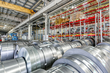 Tiered rack with sheet metal rolls. Internal warehouse of raw materials