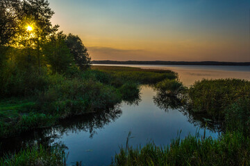 Fototapeta na wymiar Spring landscape in the evening on the lake shore