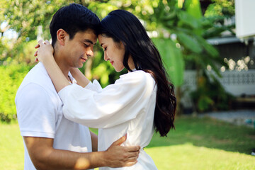 Fototapeta premium Happiness young couple family relaxation in holiday weekend at garden.