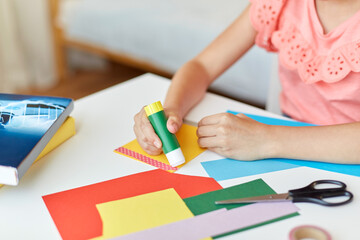 childhood, creativity and hobby concept - close up of creative girl making greeting card and...