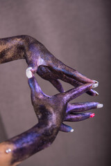 Colored hands on a gray background