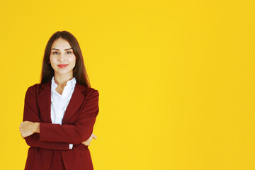 Business Caucasian woman in red suit smiling and smart isolated on yellow background.