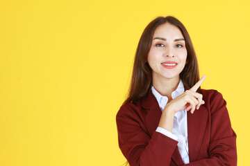 Business Caucasian woman in red suit smiling and thinking for good idea isolated on yellow background.