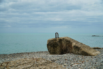 Breakwater on the beach. Ocean beach and breakwaters are close by. Old concrete blocks and Campi. High quality photo