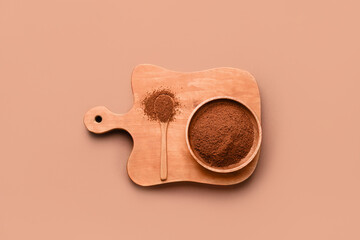 Board and bowl with coffee powder on color background