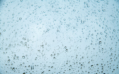 drops of water on glass with a blue tint