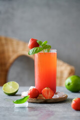 Strawberry refreshing drink on the background of rattan chairs. Summer lifestyle. Homemade Berry Lemonade