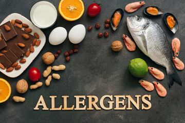 Food allergens. Seafood, milk, chocolate, nuts, citrus fruits, eggs. Allergic food concept. Top view, flat lay, copy space.