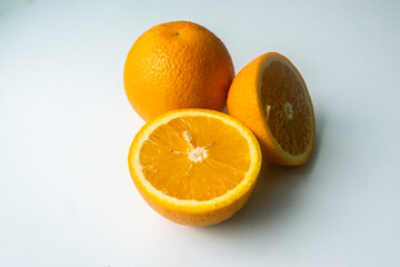 group of orange fruits isolated on a white table. cut orange. view from above