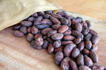 Cocoa beans at wooden background