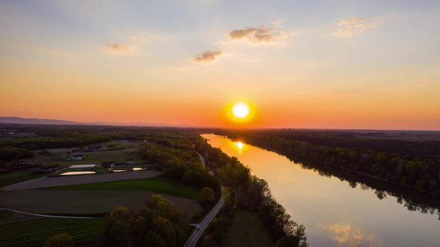 Sunset over the River Sava in Bosnia and Herzegovina. Beautiful golden hour. 5k Industrial drone hyper lapse capturing sunset in Brcko district Bosnia and Herzegovina.