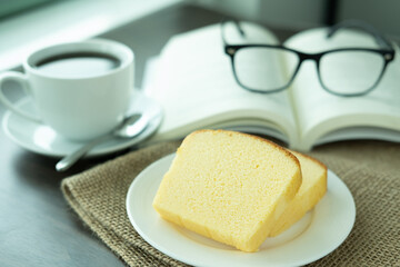 Snacks in the morning break. There are butter cakes, coffee on the table next to the window of the weekend