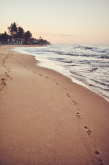 Empty tropical beach at sunrise, color toning applied, Sri Lanka.