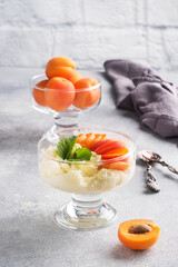 Dessert of sweet cottage cheese and fresh apricot berries with mint leaves. Copy space