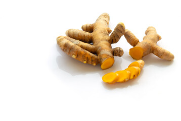 fresh turmeric root and turmeric powder in spoon on white background
