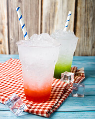 Fresh strawberry and Kiwi cocktail, cold Italian soda on wooden table