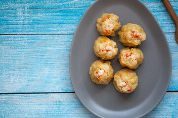 Group of hot steam shrimp dumpling served on gray dish