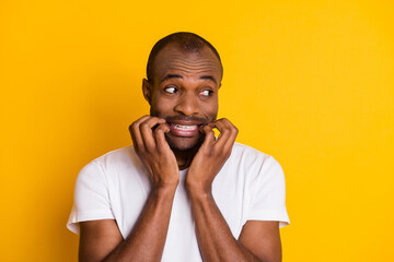 Close-up portrait of his he nice attractive funny shy guy worrying biting nails covid virus news isolated over bright vivid shine vibrant yellow color background