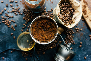 Coffee beans in an old vintage coffee grinder on a dark background. Freshly ground coffee and beans before preparing a drink