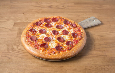 Tasty Pepperoni pizza on a wooden table