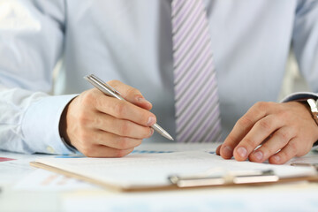 Male arm in suit and tie hold silver