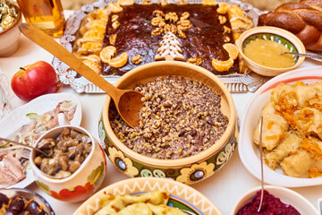 Traditional Ukrainian food. Kutya, borsch, dumplings, cabbage rolls on festive table.