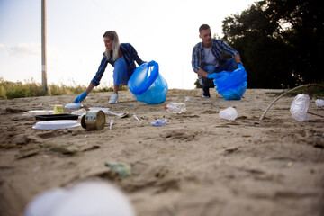 Diverse Group of People Picking Up Trash in The Park Volunteer Community Service.