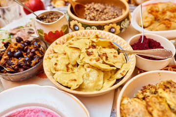 Traditional Ukrainian food. Kutya, borsch, dumplings, cabbage rolls on festive table.