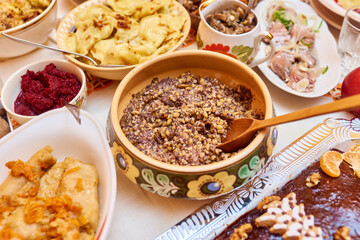 Obraz na płótnie Canvas Traditional Ukrainian food. Kutya, borsch, dumplings, cabbage rolls on festive table.