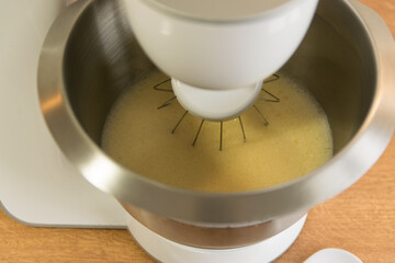 Metal dough with biscuit and electric mixer.