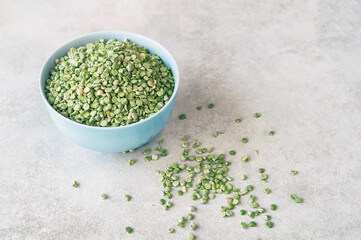 Beautiful healthy food background. Dry green peas in a bowl on a light background. Fiber intake serves as an important factor in weight loss by functioning as a “bulking agent” in the digestive system