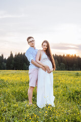 Loving couple in the field. Sunset.