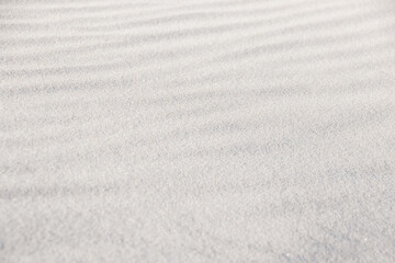 Sand, beach, nature, background. Focus on the foreground. Background of the sand. Selective focus of light sand on the beach. Close-up.