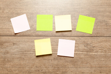 Colored stickers note isolated on wood  background
