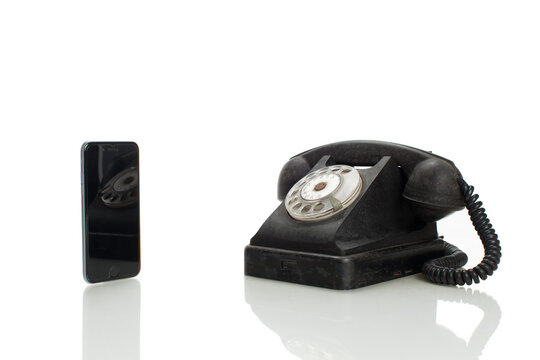 difference between old telephone and modern smart phone isolated on white background with copy space for text
