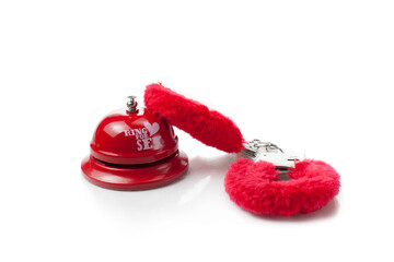 Sex toys - ring for sex bell with  red handcuffs on isolated white background 