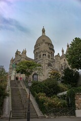 Fototapeta na wymiar Beautiful, peaceful photo of the lonely Basilica of the Sacred Heart of Paris (Basilique du Sacré-Cœur), Montmartre, France at sunrise with no people