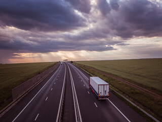 Long Semi Truck on High Way - beautiful skyline 