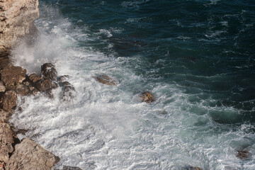 Ocean wave background breaking sea water rocky shore