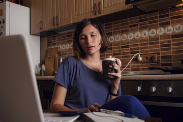 Asian Woman freelancer lecture and working on laptop at home.