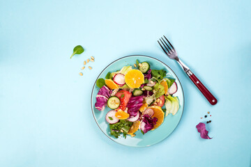 Orange with rocket and lettuce salad in a bowl