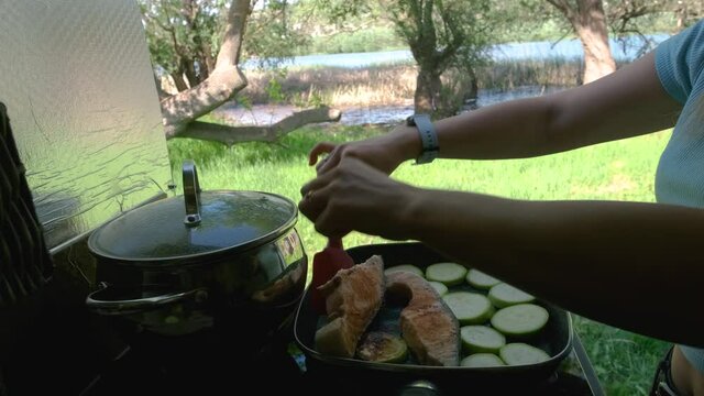 Women preparing the food in a motorhome in the nature near a river
