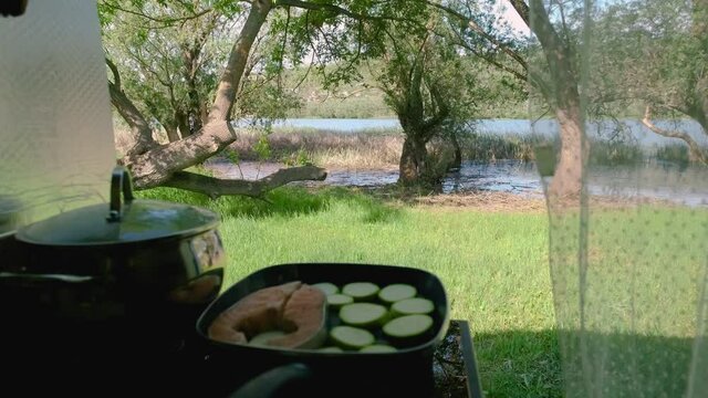 Coocking food in a van in the nature near a river