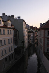 Fototapeta na wymiar A small canal between old Prague houses.
