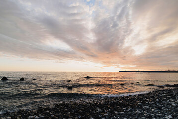 Obraz premium Beautiful sunset on the Black sea. rocks on the sea surf. 