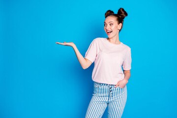 Portrait of her she nice-looking attractive pretty lovely cheerful cheery glad girl holding on palm copy empty blank space place isolated on bright vivid shine vibrant blue color background