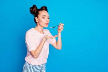 Photo of pretty lovely lady two funny buns blowing spoon hot soup meal cooking tasty meal overjoyed hungry wear casual pink t-shirt isolated bright blue color background