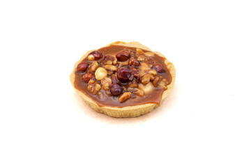 A round cake basket with condensed milk and nuts. Close-up on white background