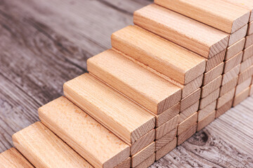 Wooden toy blocks as stairs. Business development and growth concept